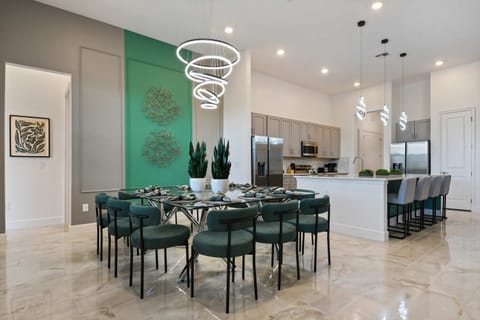 Dine in style in the elegant dining area, featuring a large table, perfect for family meals and gatherings.