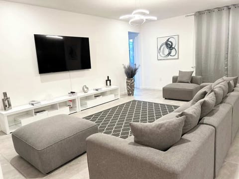 Spacious living room with plush seating and natural light — perfect for family gatherings after Disney days.
