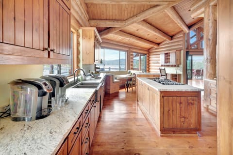 Spacious open kitchen with hardwood floors and lake views