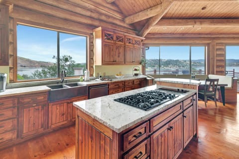 Gourmet kitchen with granite counters and panoramic lake views

