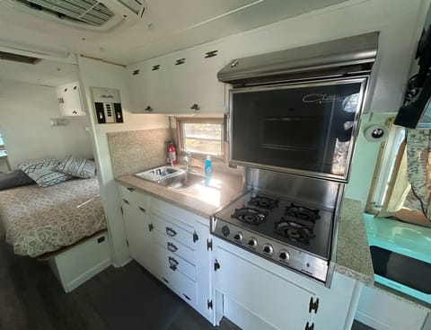 The kitchen includes a stove and oven, perfect for cooking.