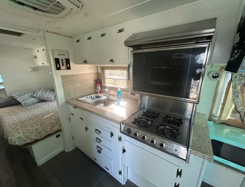 The kitchen includes a stove and oven, perfect for cooking.