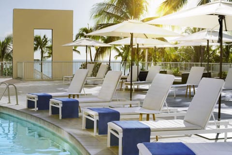 Lounge under umbrellas and savor warm ocean breezes poolside.