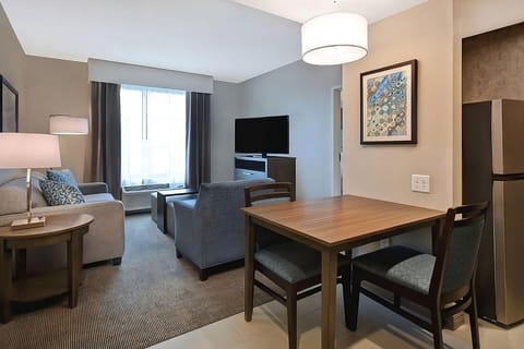 Gather for meals at a roomy table beside the lounge.
