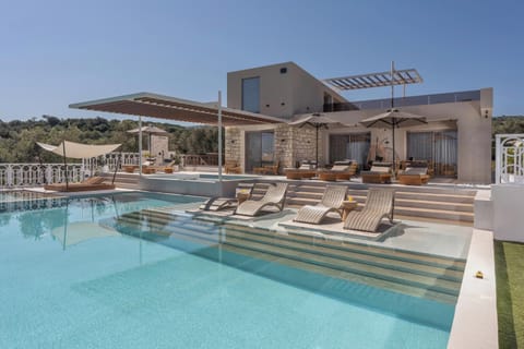 The pool area is equipped with 10 sun beds, side tables, a poolside shower, and 3 umbrellas