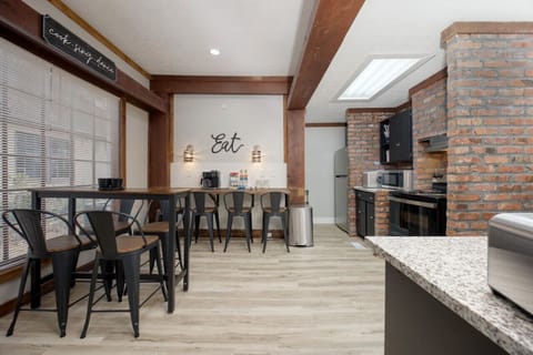 Large, fully stocked kitchen with seating and tableware for 12 guests.