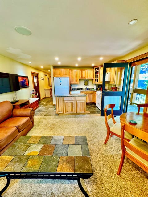 Open concept kitchen / living / dining space opens up to the deck outside.