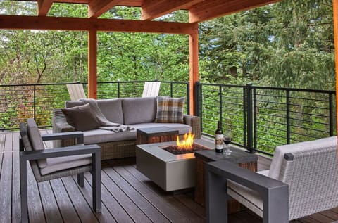 Relax on the expansive deck with stylish outdoor furniture and stunning forest views.