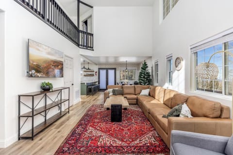 Living room with vaulted ceiling, open floor concept and massage chair. 