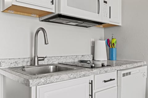 Perfect little kitchenette with 2 burner cooktop, microwave, and dishwasher.  We also have a crock pot.