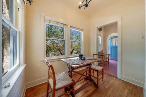 Cozy dining space with seating for two and views of the lovely front yard