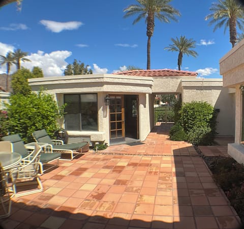 Private garden patio with table, chairs & loungers