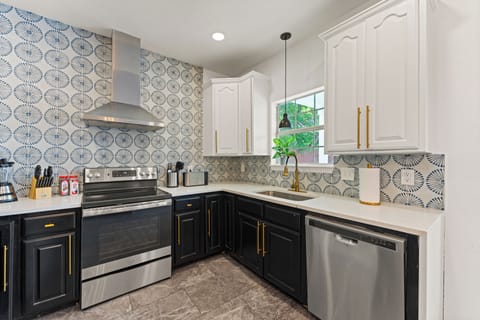 Full Kitchen with Bespoked Fridge and Stainless Steel Appliances