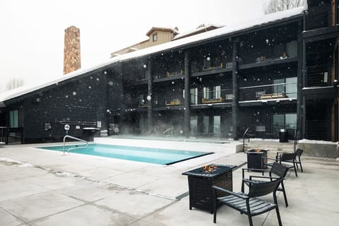 Linger poolside with fire tables and falling snow.
