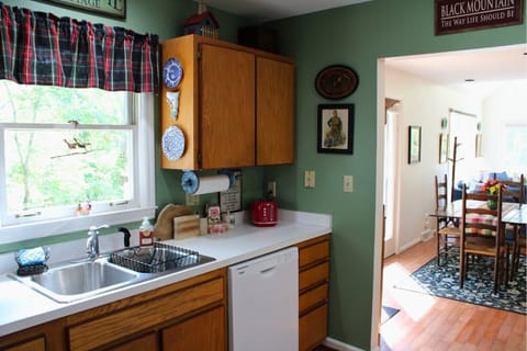 Kitchen with dishwasher, Dutch oven, blender, food processor & standard drip coffeemaker.