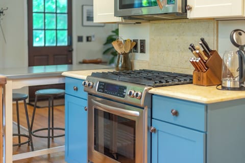 Kitchen with bar seating for 2 & gas range stove.