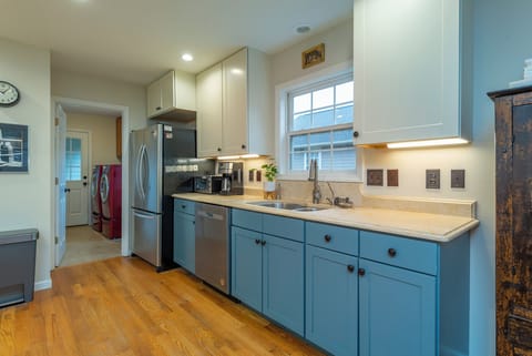 Kitchen with bar seating for 2, gas range, dishwasher & standard drip coffeemaker.
