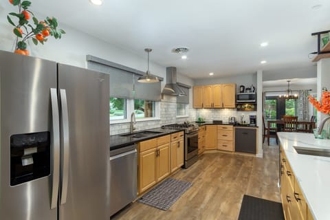 Kitchen with gas range stove, dishwasher, and 2 types of coffeemakers (French Press & Drip-style).