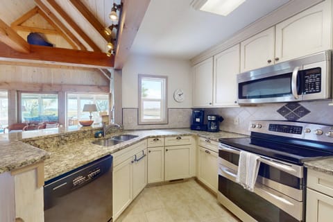 The kitchen features stainless steel appliances and everything you need to make a great meal
