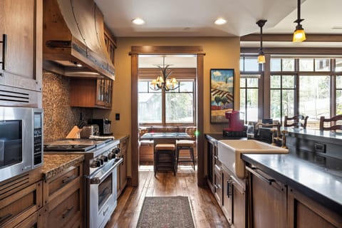 - Spacious and clean galley kitchen with a deep farmhouse sink and stone toned counters
- Enjoy your morning brew under warm pendant lights and window filled walls
- Dine in a sunlit breakfast nook with mountain views and cozy seating