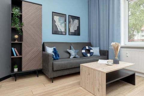 Relax in the stylish living room with a comfortable sofa and modern decor.