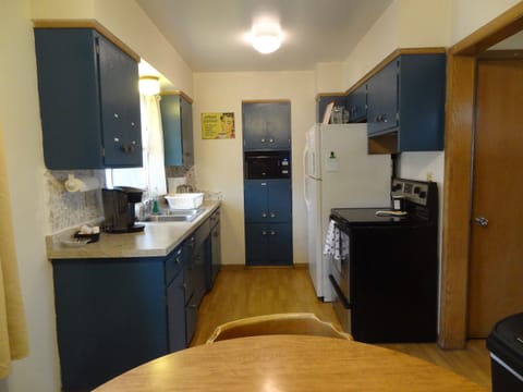 Kitchen with full stove and refrigerator
