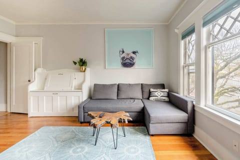 Living room with sofa and bright windows.