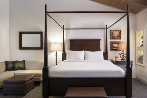 Sink into crisp linens beneath a dramatic four-poster canopy.