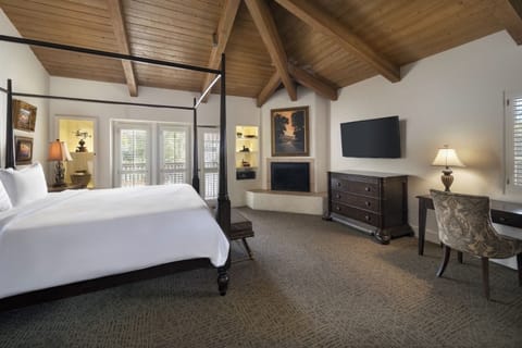 Stretch out in an airy bedroom with warm wood ceilings.