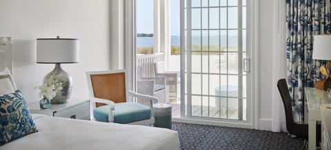 Unwind by the sliding doors as waves glimmer outside.