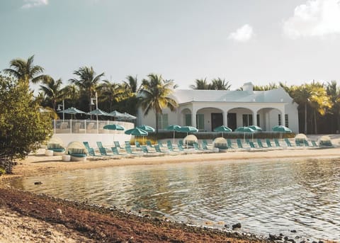 Unwind steps from the shore with loungers and sea views.