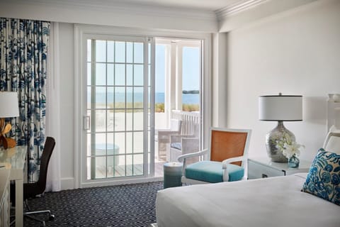 Breathe in coastal calm from bed with beach views ahead.