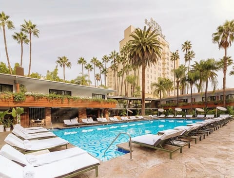 Stretch out on plush loungers beside the sparkling turquoise water.