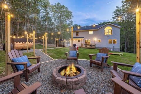 This is  the view from the back corner of the property highlighting a lot of our backyard amenities.  Pocono Mountains Family Friendly & Kid Friendly Amenities, Hot Tub, Sauna, Fire Pit, Grill, Game room, Gaming stations, Pool, Ski, Hike