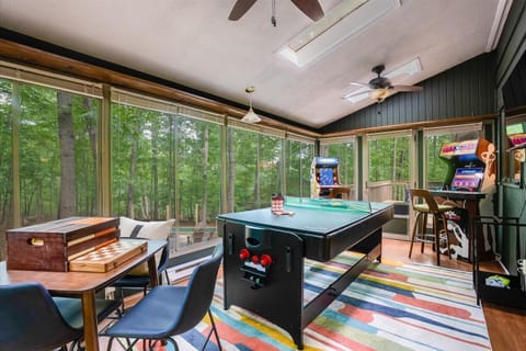 Nature meets entertainment in our game room, where expansive windows showcase breathtaking tree-lined vistas (XBOX no longer available)