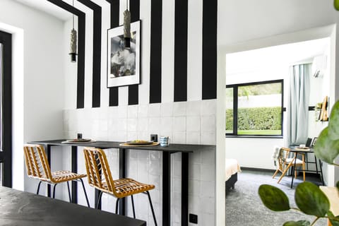 Stylish Dining: Savor your meals at the sleek bar with two chairs, ideal for intimate breakfasts or cozy dinners.