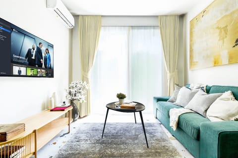 Relax in Comfort: Unwind on the plush sofa with a view of the small inner yard, perfect for relaxation and rejuvenation.