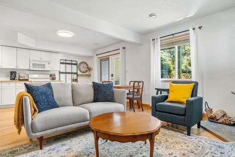 Living room with cozy seating, a Smart TV, wood-burning fireplace & board games. Please note that wood is not stocked on the property.