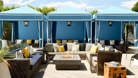 Gather with friends around the glowing fire in stylish seating.