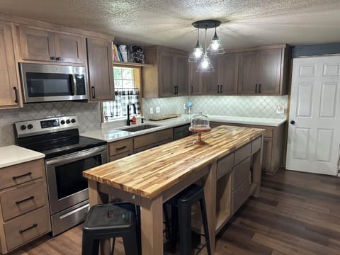 Gourmet kitchen with luxury quartz countertops, extra large cabinets.