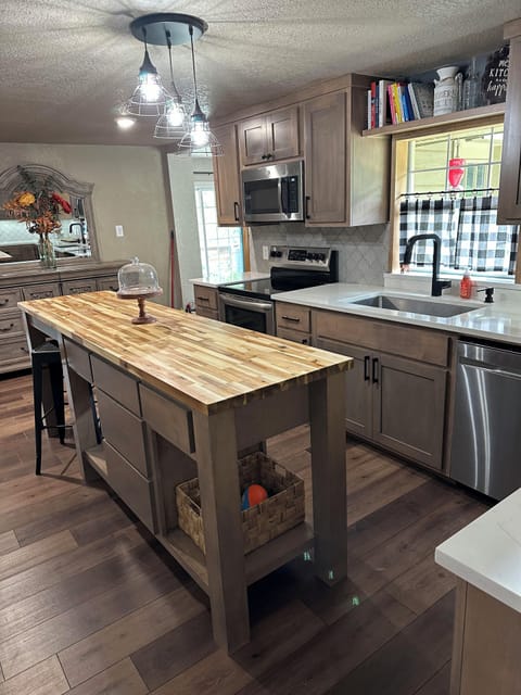 Large butcherblock island and an extra large farmhouse sink.