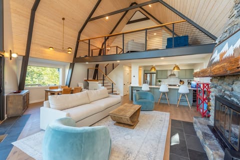 Living room with wood-burning fireplace, Smart TV (streaming and cable available).