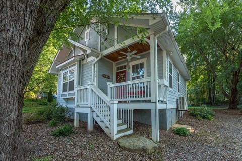 A welcoming facade featuring classic Arts & Crafts architecture, nestled in a quiet neighborhood with mature trees and a well-maintained lawn.
