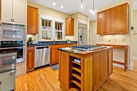Sleek kitchen complete with stainless appliances, gas range stove, and dishwasher.