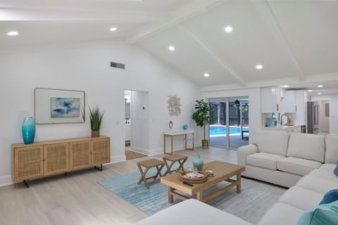Gorgeous light filled family room with Smart TV and skylight, easy access to pool via slider adjacent to kitchen