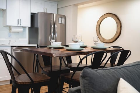 - Dining table set for six with elegant dishware included  
- Modern kitchen with stainless steel appliances nearby  
- Perfect spot to enjoy meals with family and friends  
