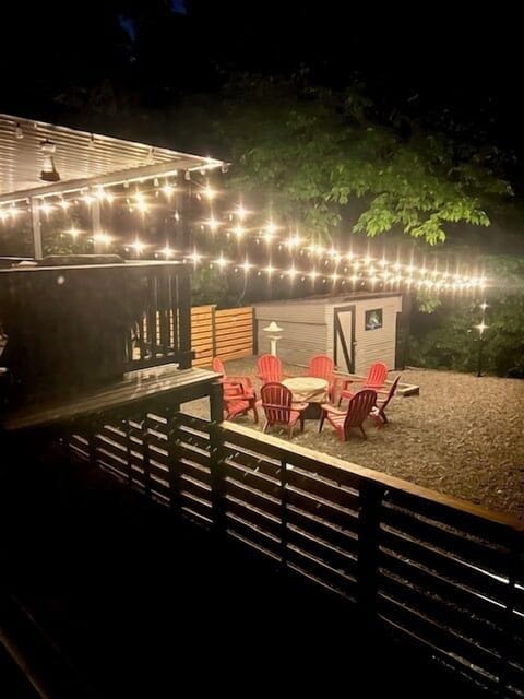- Backyard lit up with glowing string lights at night  
- Fire pit seating creates a magical evening ambiance  
- Perfect outdoor setup for stargazing and gatherings  
