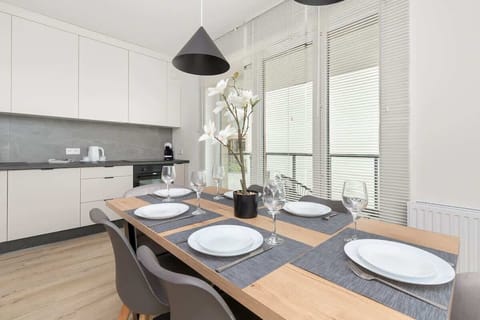 A kitchen with a dining area in a cohesive, modern design invites you to cook together and enjoy meals in style.