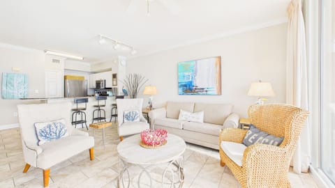 Open concept living area with coastal decor throughout and TV + sleeper sofa (sleeps 2)
