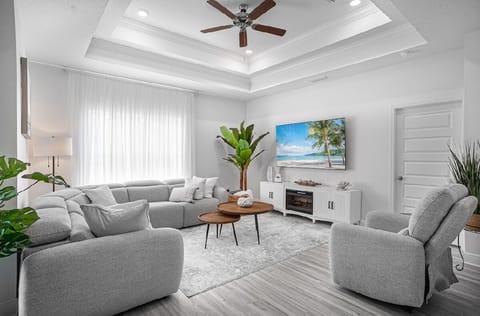 In the living room plentyof space  for everyone to rest confortably on a large .